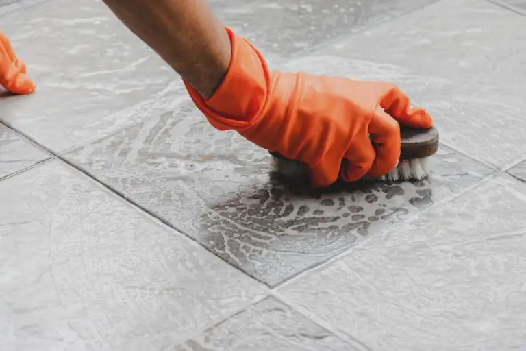 person using grout cleaner on tile