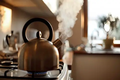 a stove top kettle with steam coming out of it