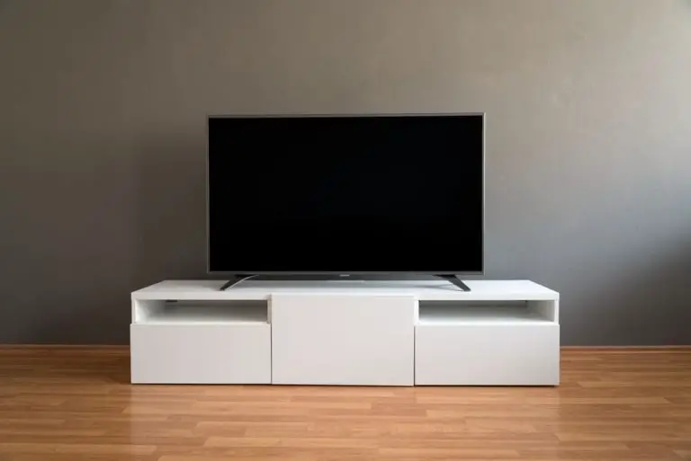 a tv stand with a 65 inch tv on it
