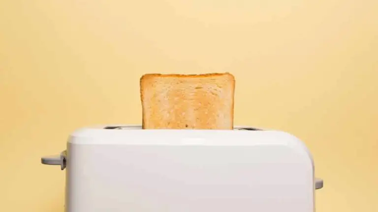 a smeg toaster with a peice of freshly toasted bread in it