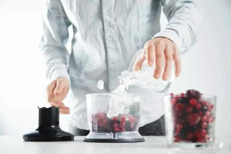 man pouring ice into blender for crushing ice