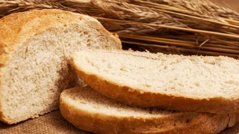 Sliced artisan bread on table for best long slot toaster