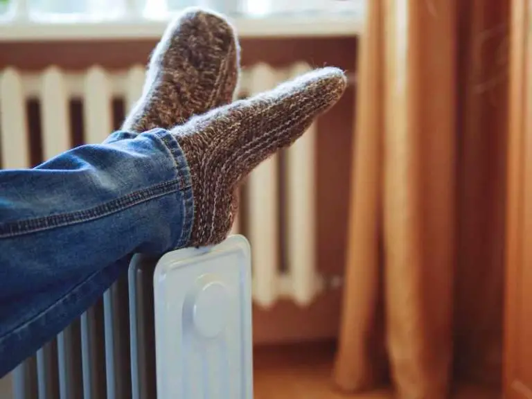a space heater warming up a persons feet