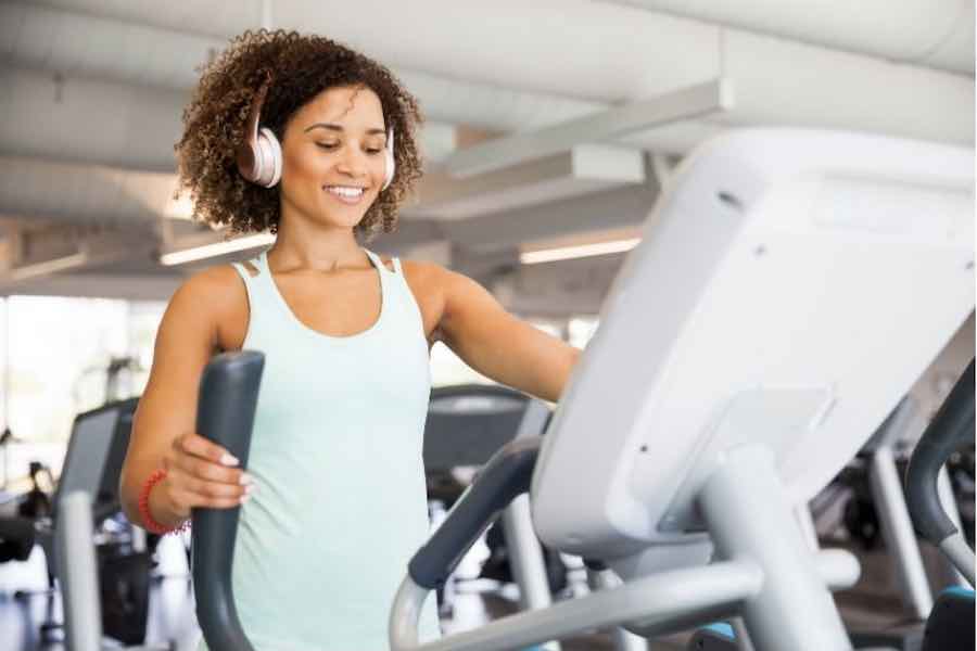 A woman exercising on an elliptical machine