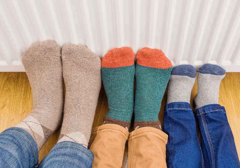 Family warming their feet safely 