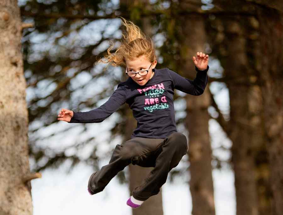 wooded location for child jumping on trampoline