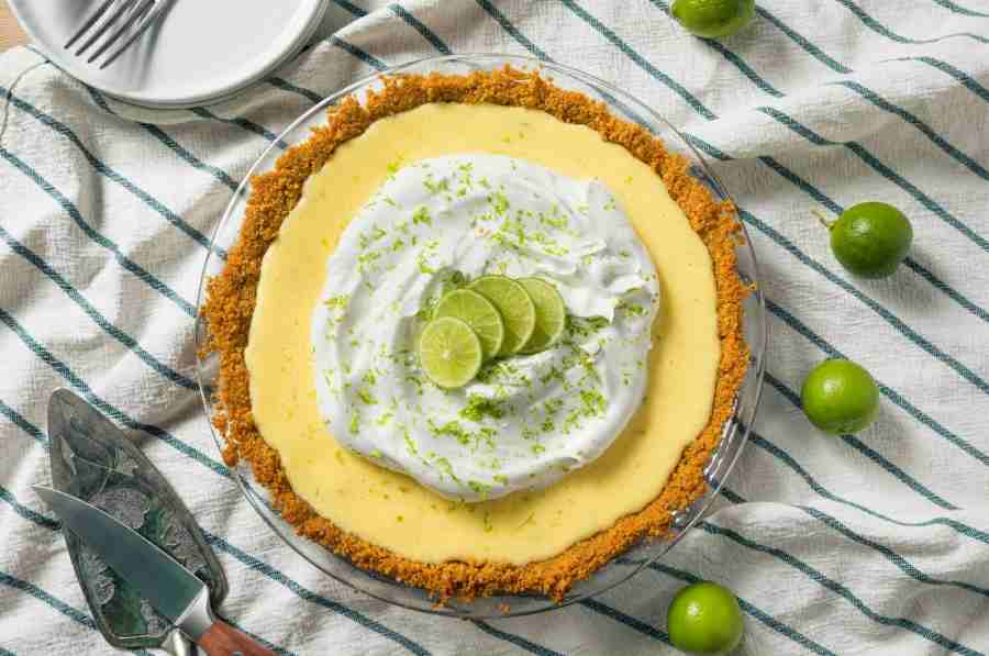 Key Lime Pie garnished with juicy key limes