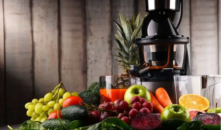 Cold press juicer with fruits and vegetables