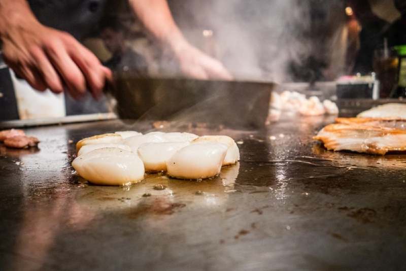 Chicken breast cooking on a blackstone griddle 