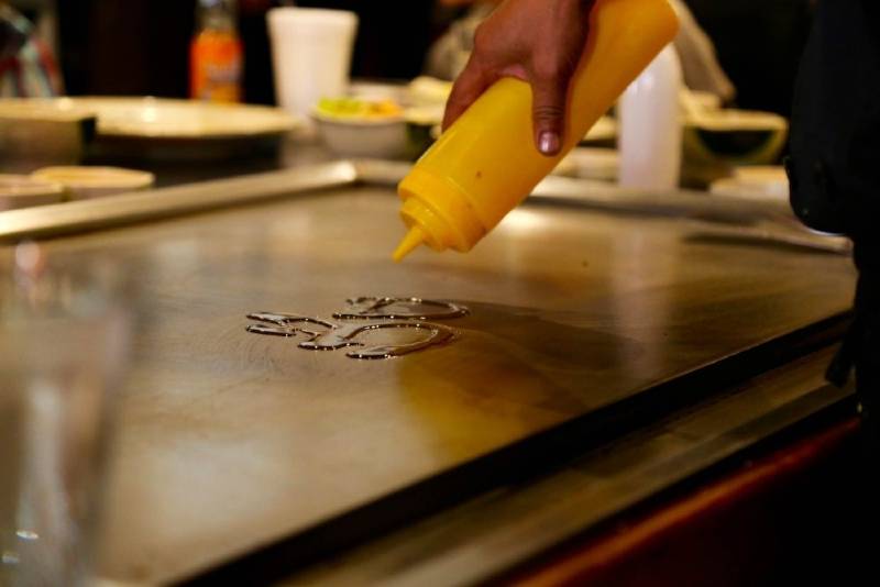 Pouring oil on the cooking surface 