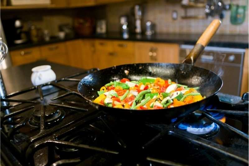 The process of stir frying on a pro-style gas range 