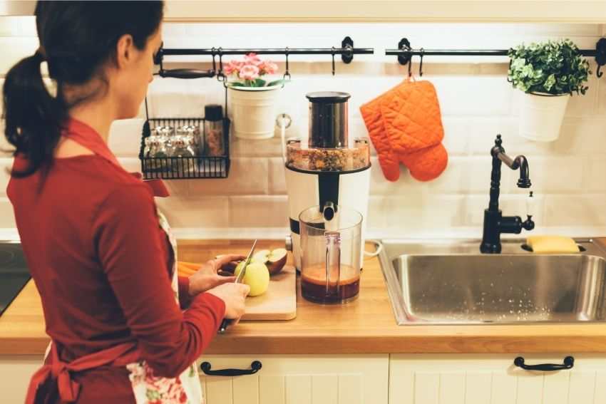 Woman preparing fruit for juicing 