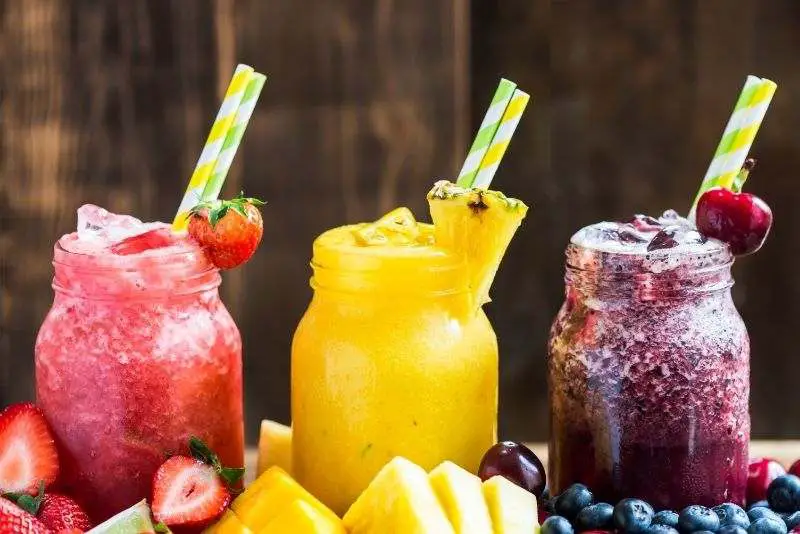 three mason jars full of blended frozen drinks