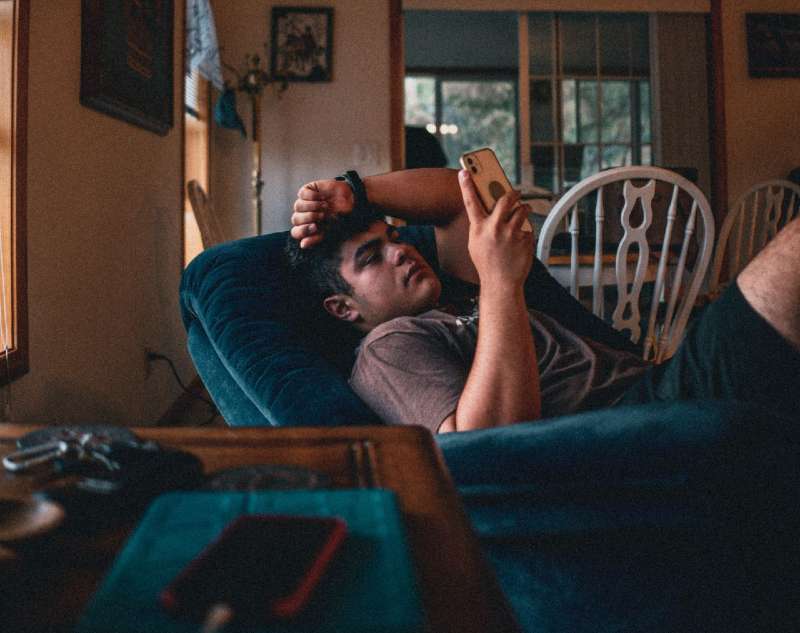 A young man relaxing in a Lazy Boy recliner 