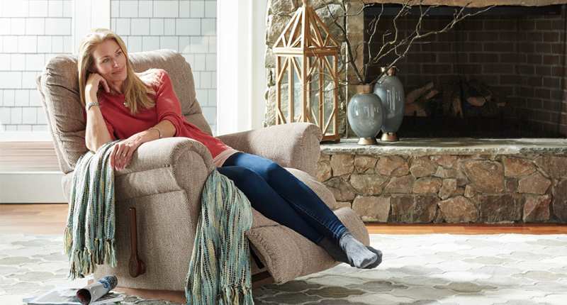 A woman relaxing in a large comfy recliner 