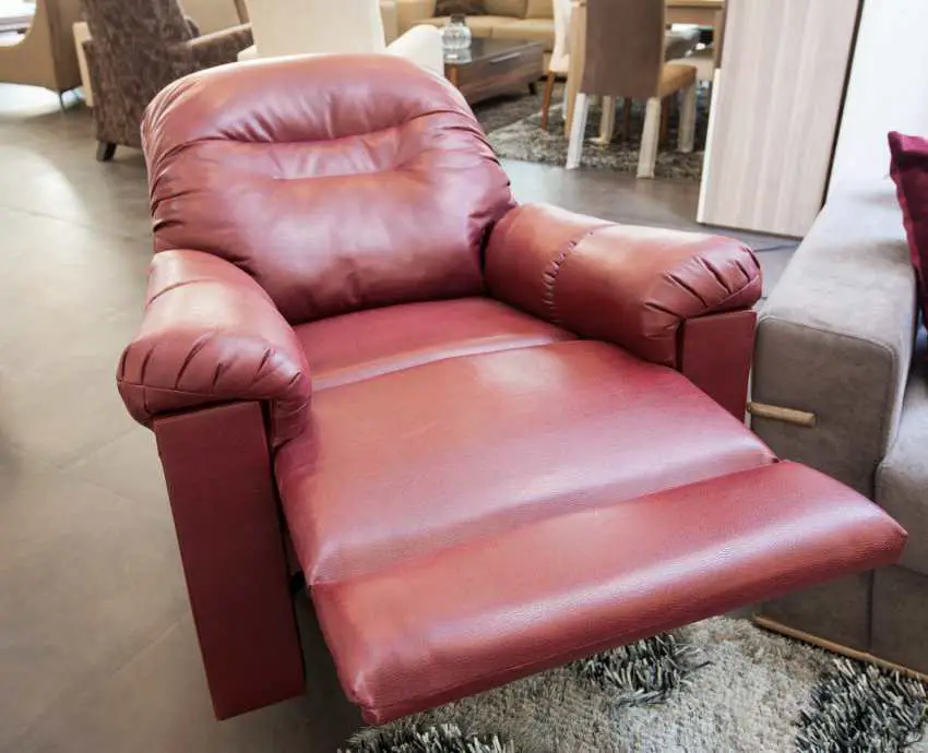 A red leather recliner with the footrest extended
