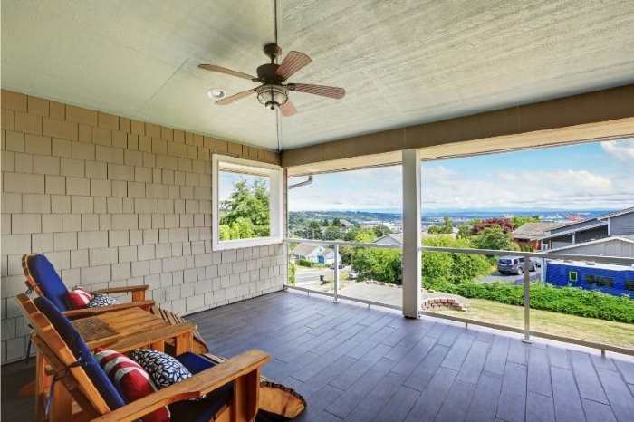 A 5-blade outdoor ceiling fan on a patio ceiling