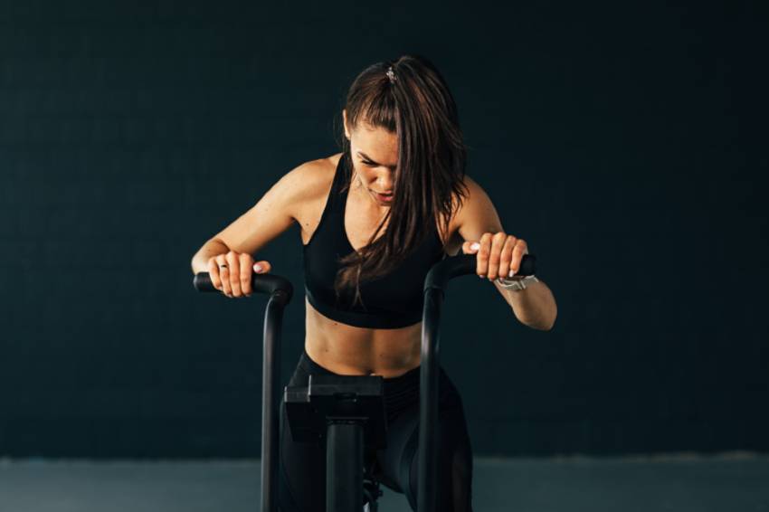 A young woman exercising on an air bike