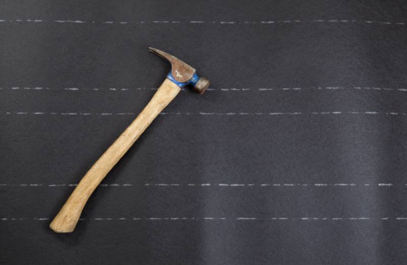 A hammer on some roof underlayment