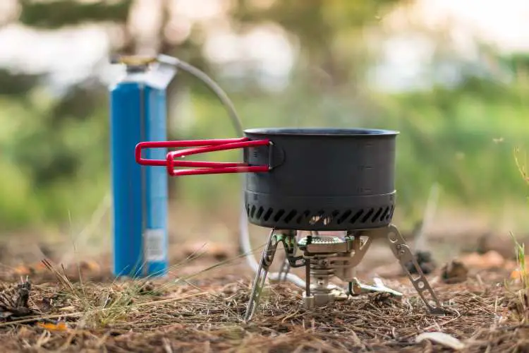 A propane stove used to boil water in the wild