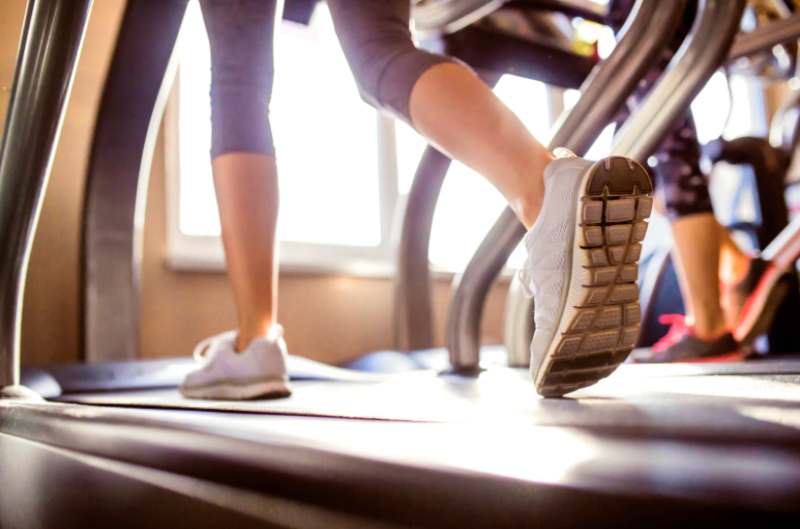 A close-up of people running on a treadmill