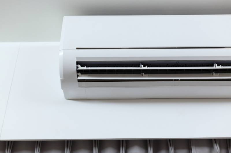 Air conditioner unit installed on a white wall 