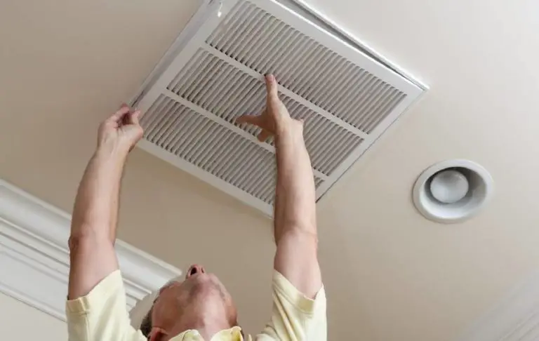 Man installing 20x30x1 air filter in home