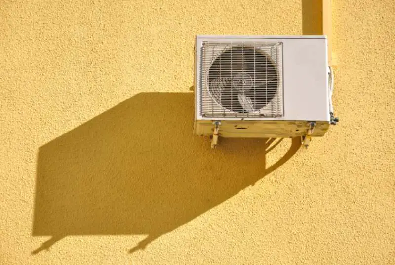 The AC outter unit installed on the side of a building