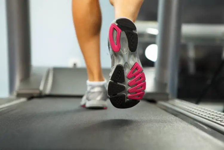 A close-up of a person running on a treadmill